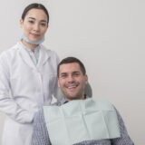 Happy patient showing bright white smile after cosmetic treatment at Meadowvale Dentistry Mississauga.